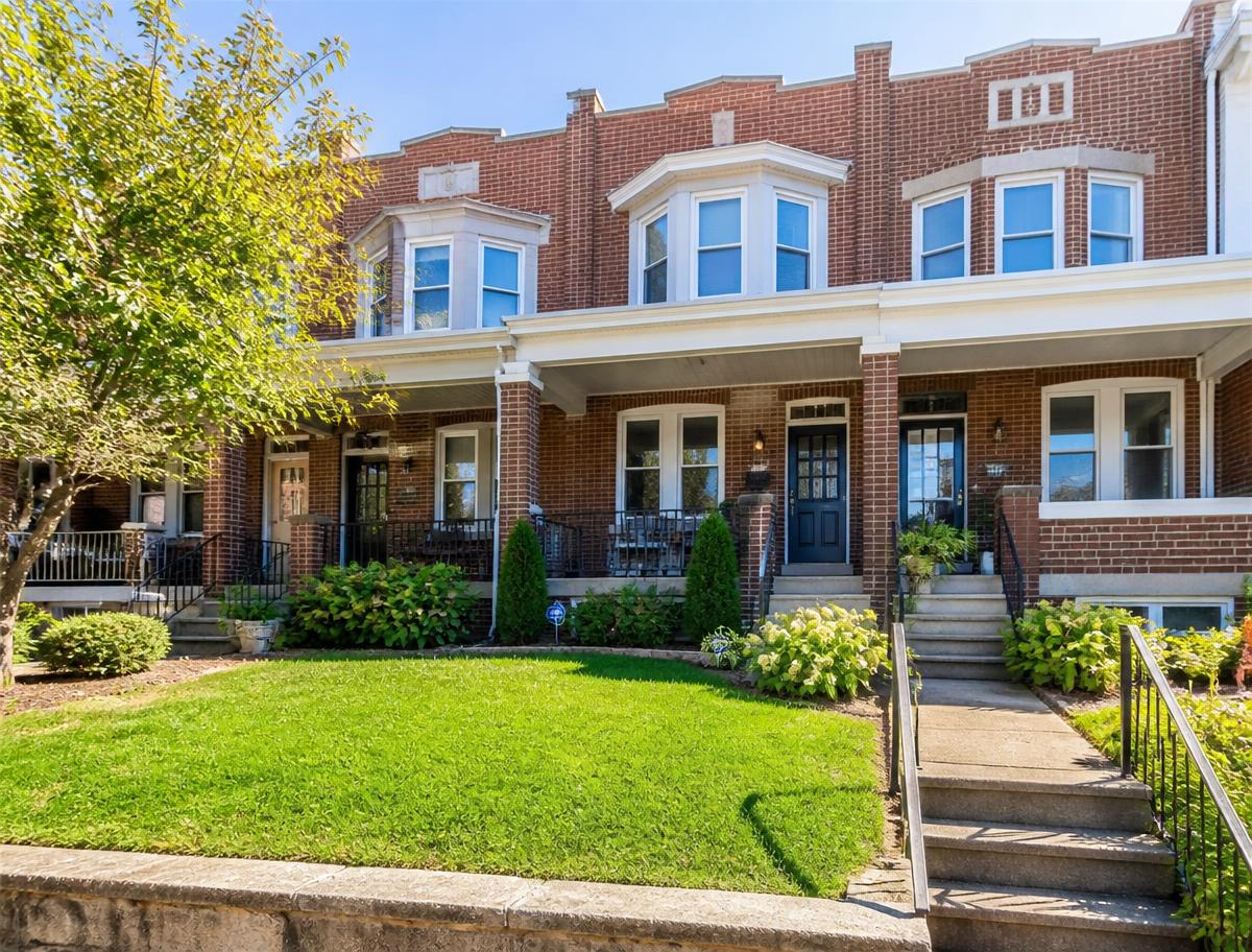 A classic Philadelphia townhouse with a well-maintained front lawn